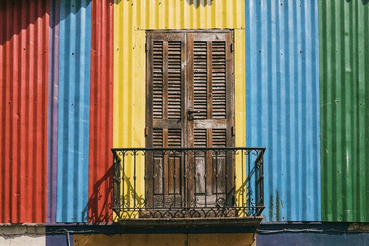 Brightly painted corrugated-metal facade with a wrought-iron balcony in La Boca, Buenos Aires (illustrative image)